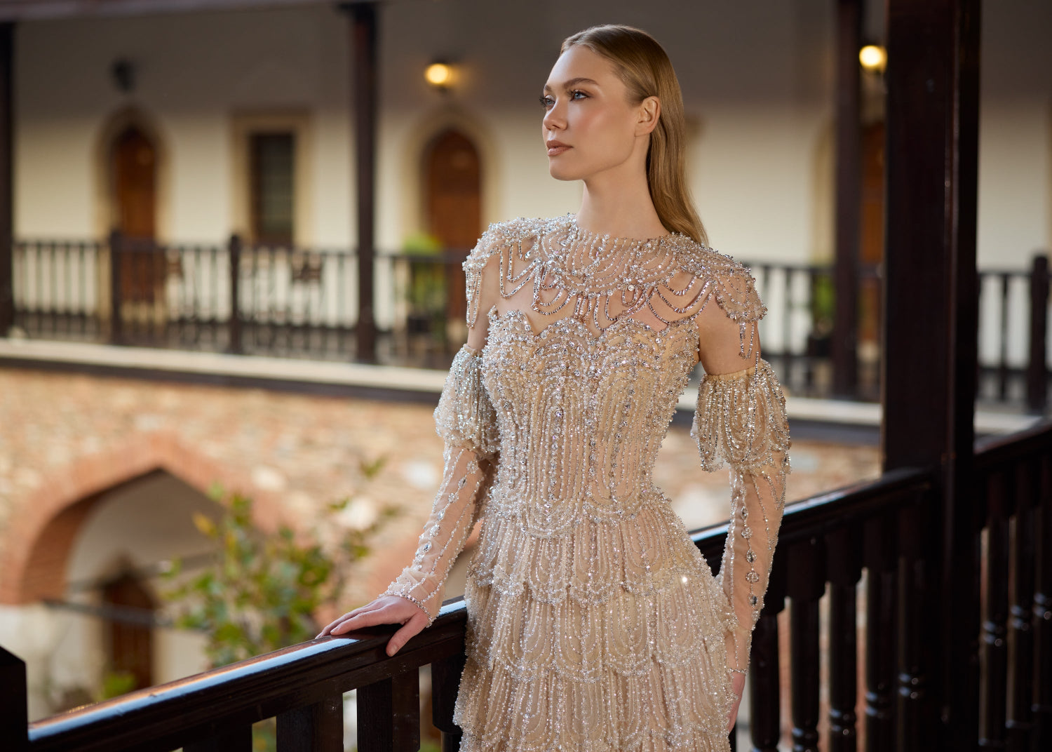 Detailed close-up of the champagne bridal corset bodice, highlighting the intricate hand-beaded detachable illusion high-collar and cold-shoulder sheer sleeves.