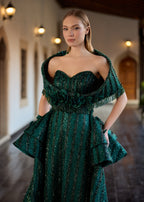Close-up of the sweetheart corset bodice, highlighting the detailed detachable fringed shoulder shawl and the row of handcrafted 3D emerald fabric roses at the waist.