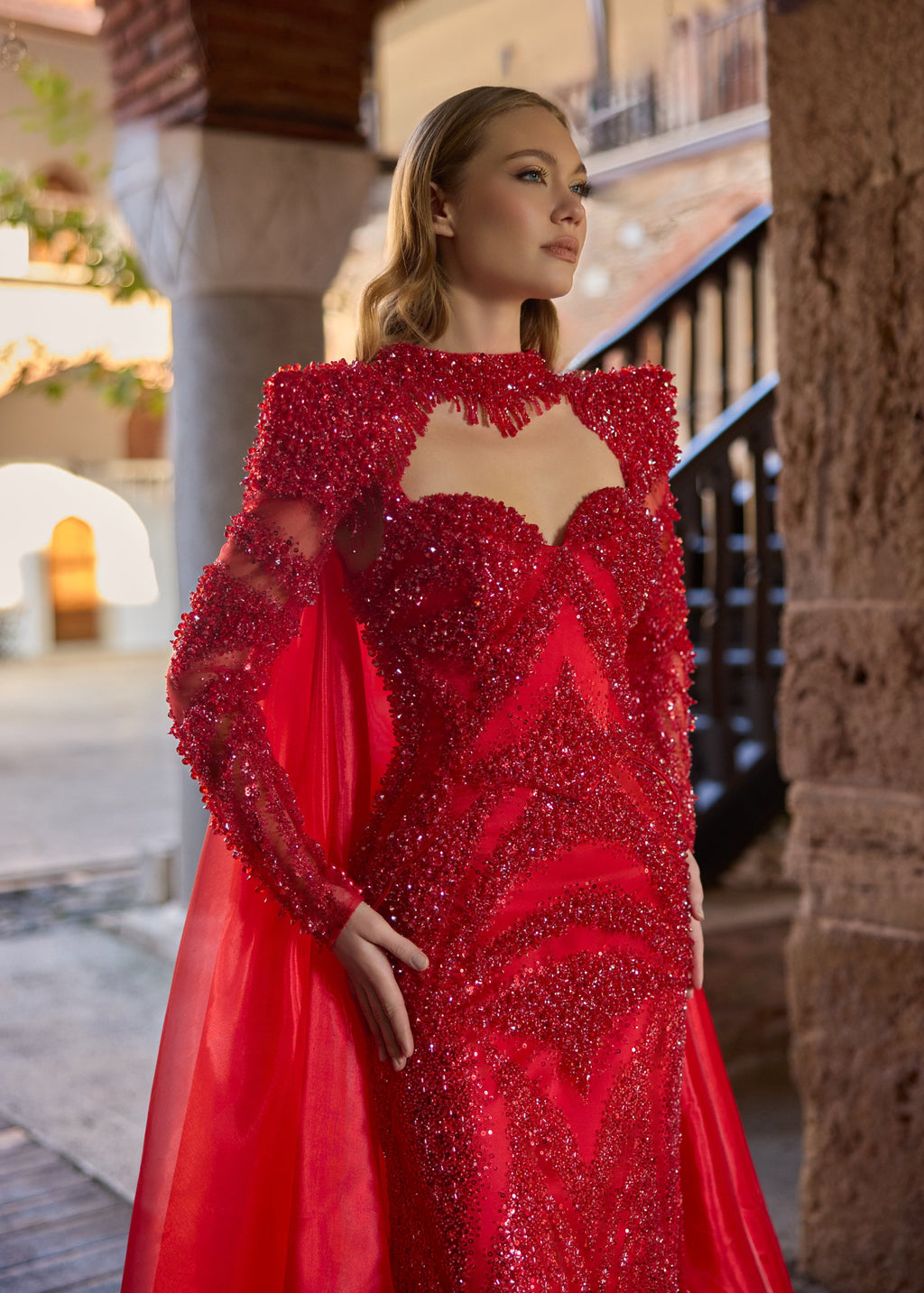 Close-up of the detailed geometric red beadwork and sequins, featuring the sweetheart neckline and intricate hand-beaded fringe collar of the luxury red bridal gown.