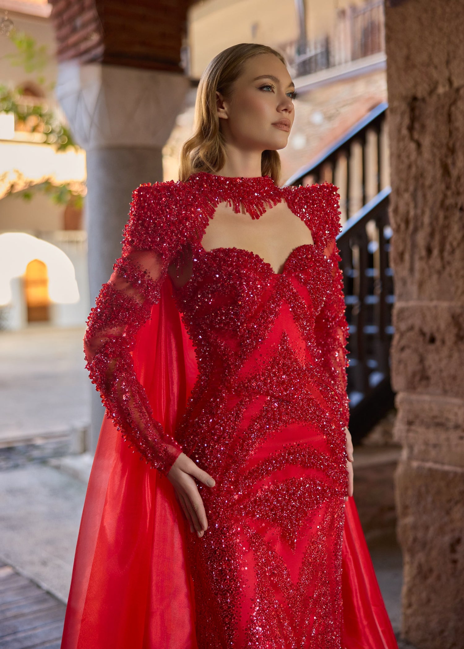 Close-up of the detailed geometric red beadwork and sequins, featuring the sweetheart neckline and intricate hand-beaded fringe collar of the luxury red bridal gown.