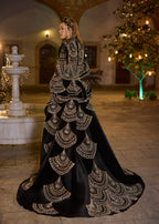 Full-length rear view showing the dramatic sweeping imperial train of the detachable velvet overskirt, intricately decorated with repeating gold hand-beaded scallop embroidery by Sultan Dress.
