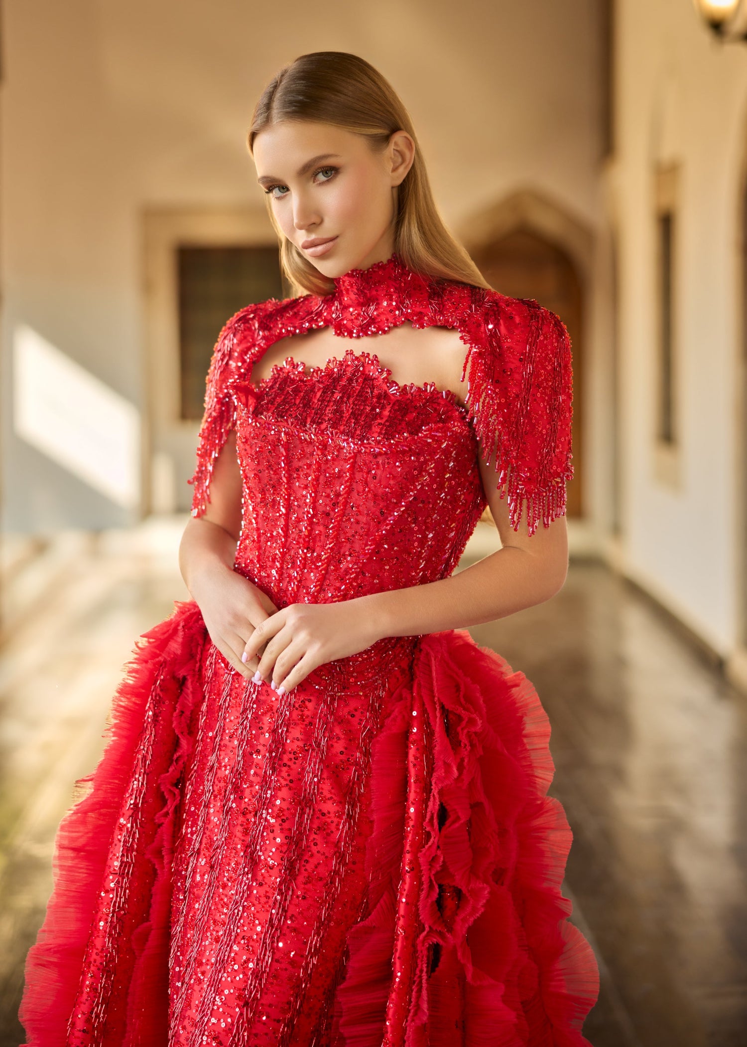 Close-up of the detailed red sequin sweetheart bodice, highlighting the intricate handcrafted high-neck collar with dangling beaded fringes.