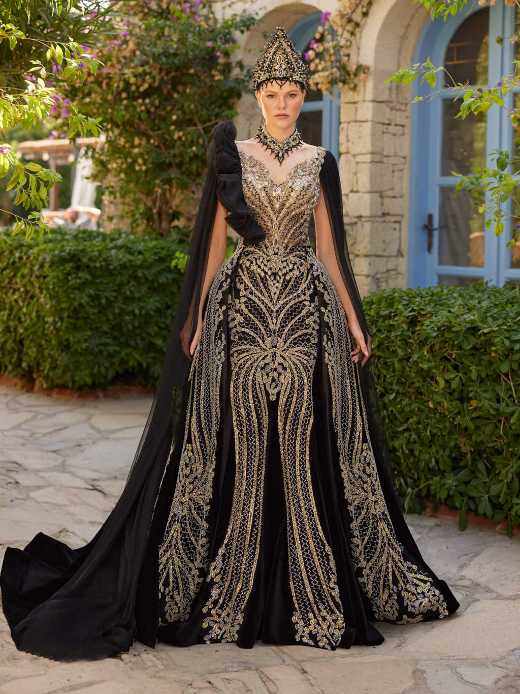 Full-length front view of the black mermaid cape gold sequin traditional henna dress with detachable train skirt, crown, and choker necklace by Sultan Dress.