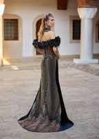 Back view of a black velvet mermaid henna dress featuring detachable overskirt, medium-length train, and handmade beadwork details.