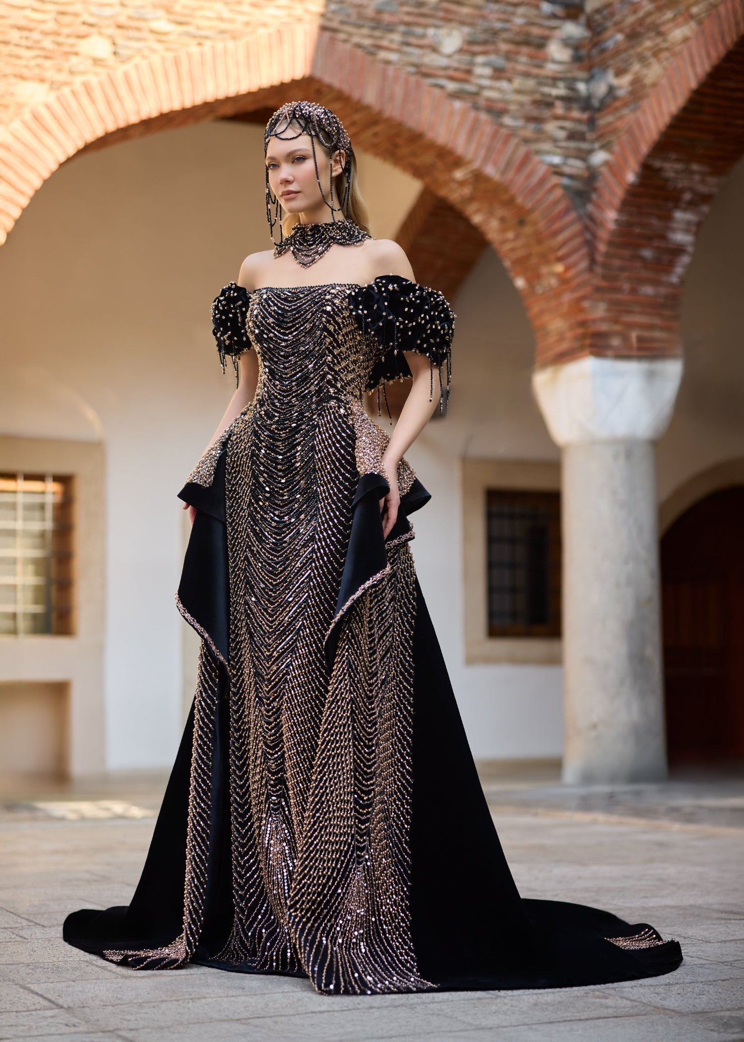 Elegant black henna dress with extensive hand-sewn gold and black bead embroidery, refined mermaid silhouette, and couture craftsmanship.