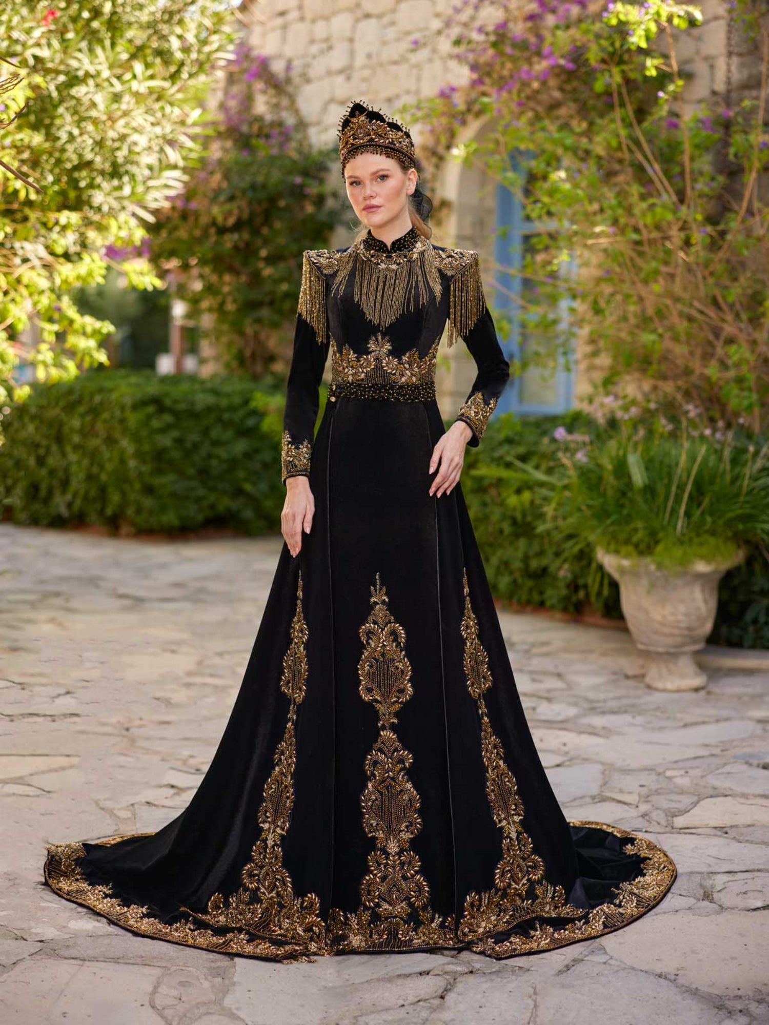 Full-length front view of the elegant black fringed embellished gold lace long henna party gown with crown by Sultan Dress.