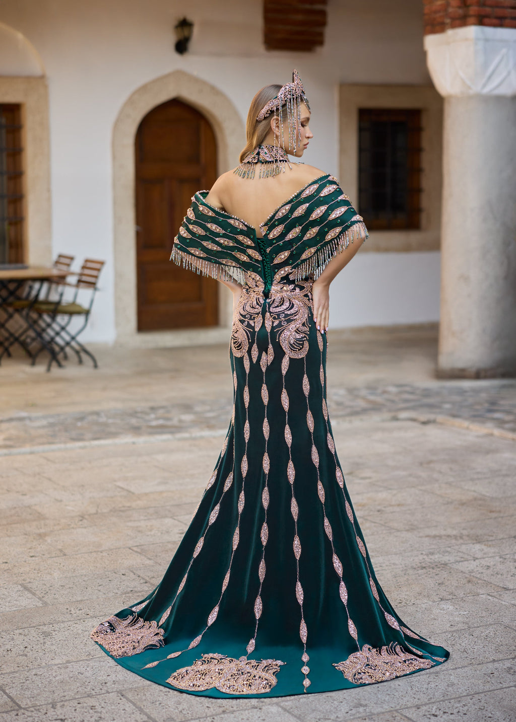 Back view of an emerald green henna dress featuring Turkish-inspired motifs, extensive bead embroidery, 