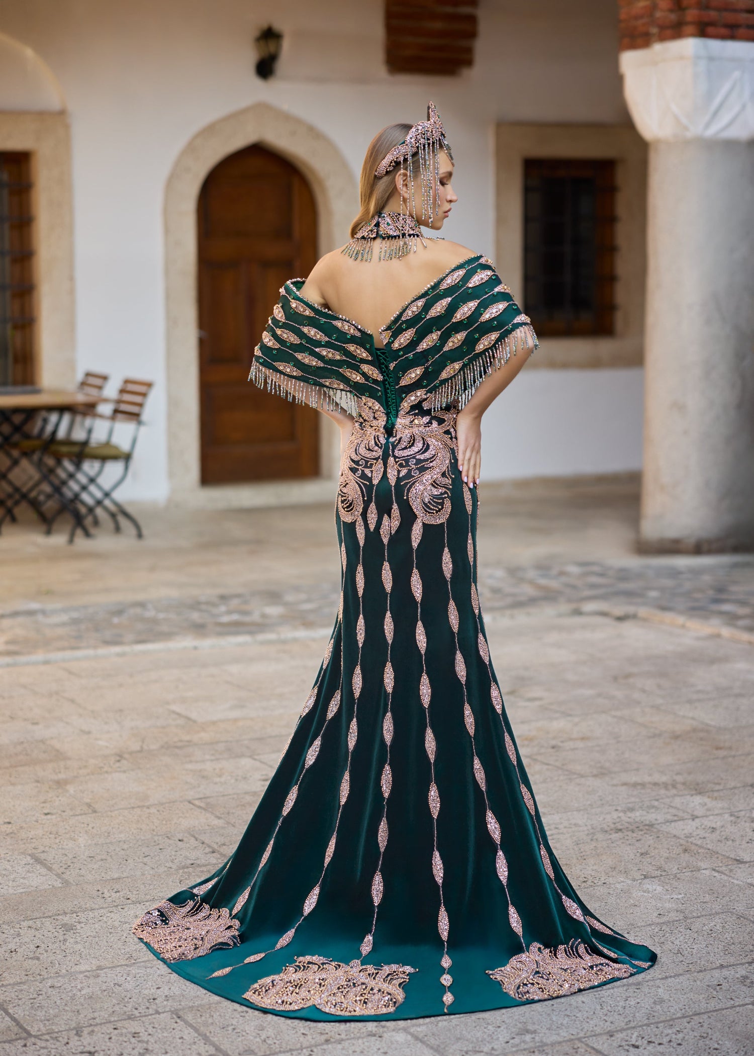 Back view of an emerald green henna dress featuring Turkish-inspired motifs, extensive bead embroidery, 
