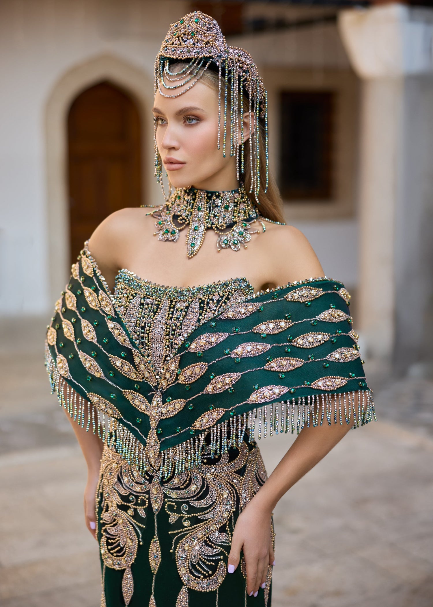 Custom-made emerald green henna dress showcasing intricate handmade bead embroidery, sparkling gemstones, and couture craftsmanship.