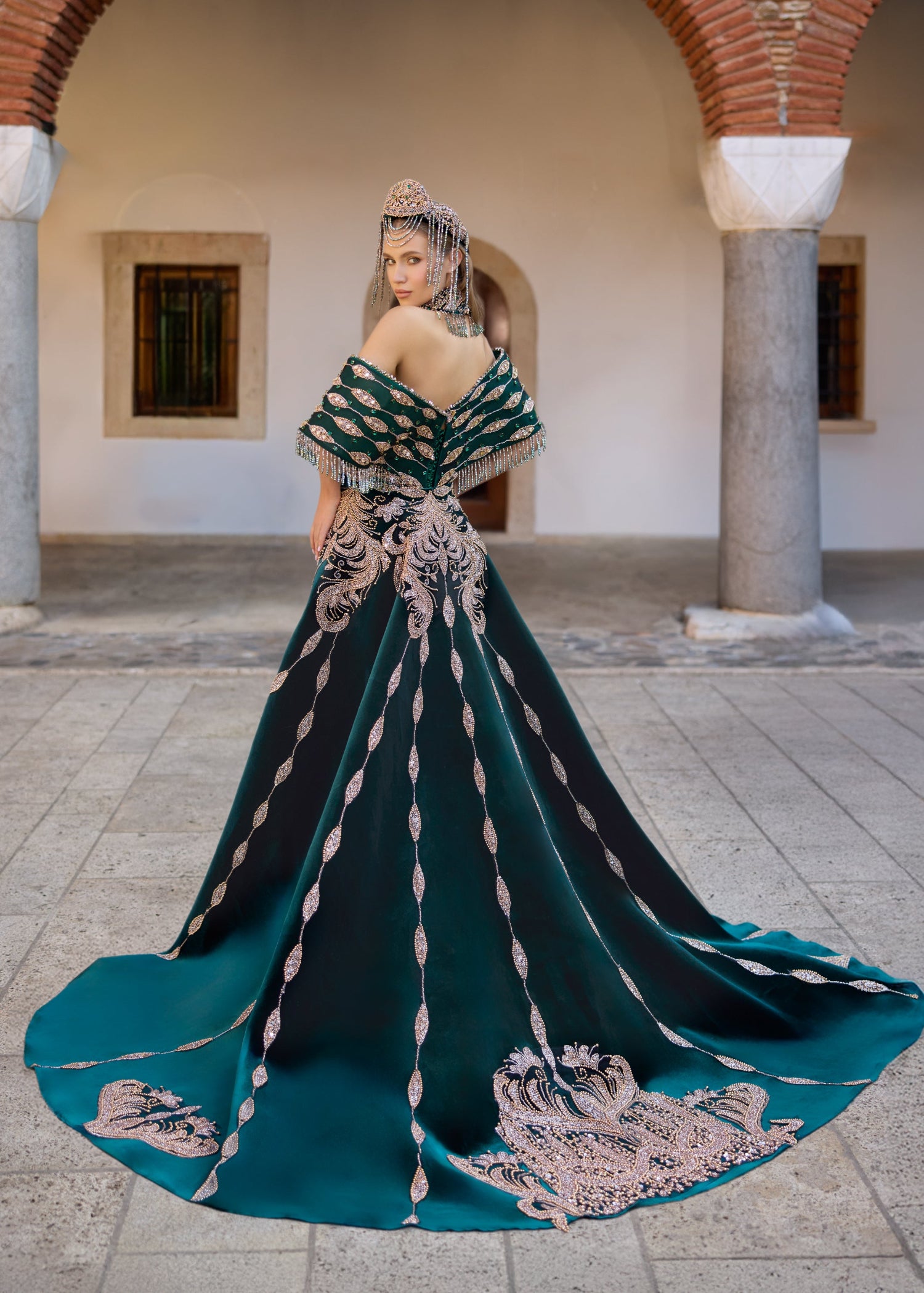 Luxury emerald green henna dress with a detachable overskirt, ornate Turkish-inspired embroidery, and heavily embellished couture detailing.
