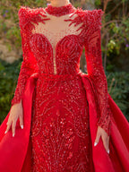 Close-up of the beaded shoulder caps, illusion V-neckline, and red sequin embroidery on the Sultan Dress evening gown.