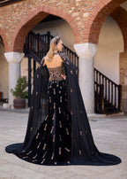 Ottoman-inspired velvet henna dress with dramatic floor-length tulle cape sleeves and a fitted mermaid silhouette.