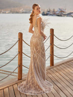 Back view showcasing the open beaded illusion back and sweeping detachable satin train on the nude sparkly formal gown.