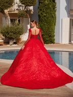 Rear view showcasing the open back with button detail and magnificent long cathedral train of the red sequin ball gown.