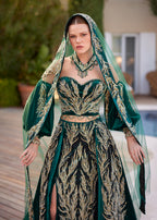 Front view of the emerald green front slit gold sequined henna gown featuring balloon sleeves, matching embroidered veil, and choker necklace by Sultan Dress.