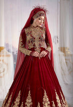 Close-up detail view of the authentic Ottoman metallic gold thread embroidery on the red Turkish caftan gown.