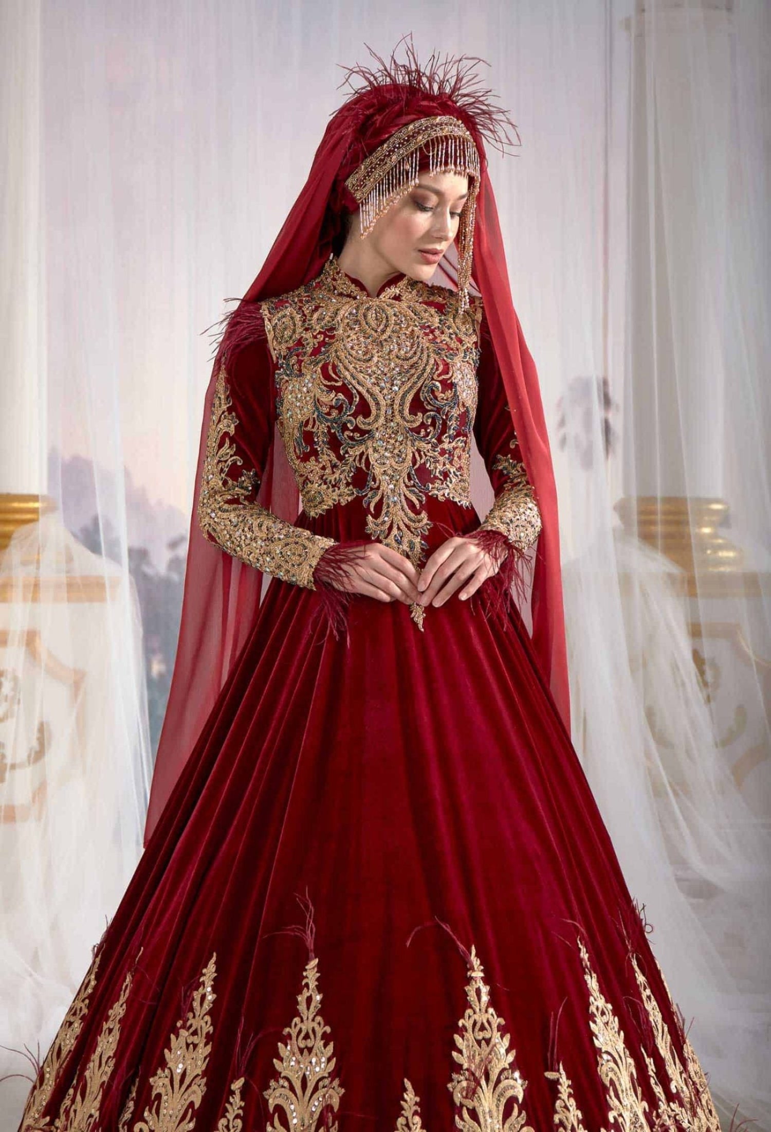 Close-up detail view of the authentic Ottoman metallic gold thread embroidery on the red Turkish caftan gown.