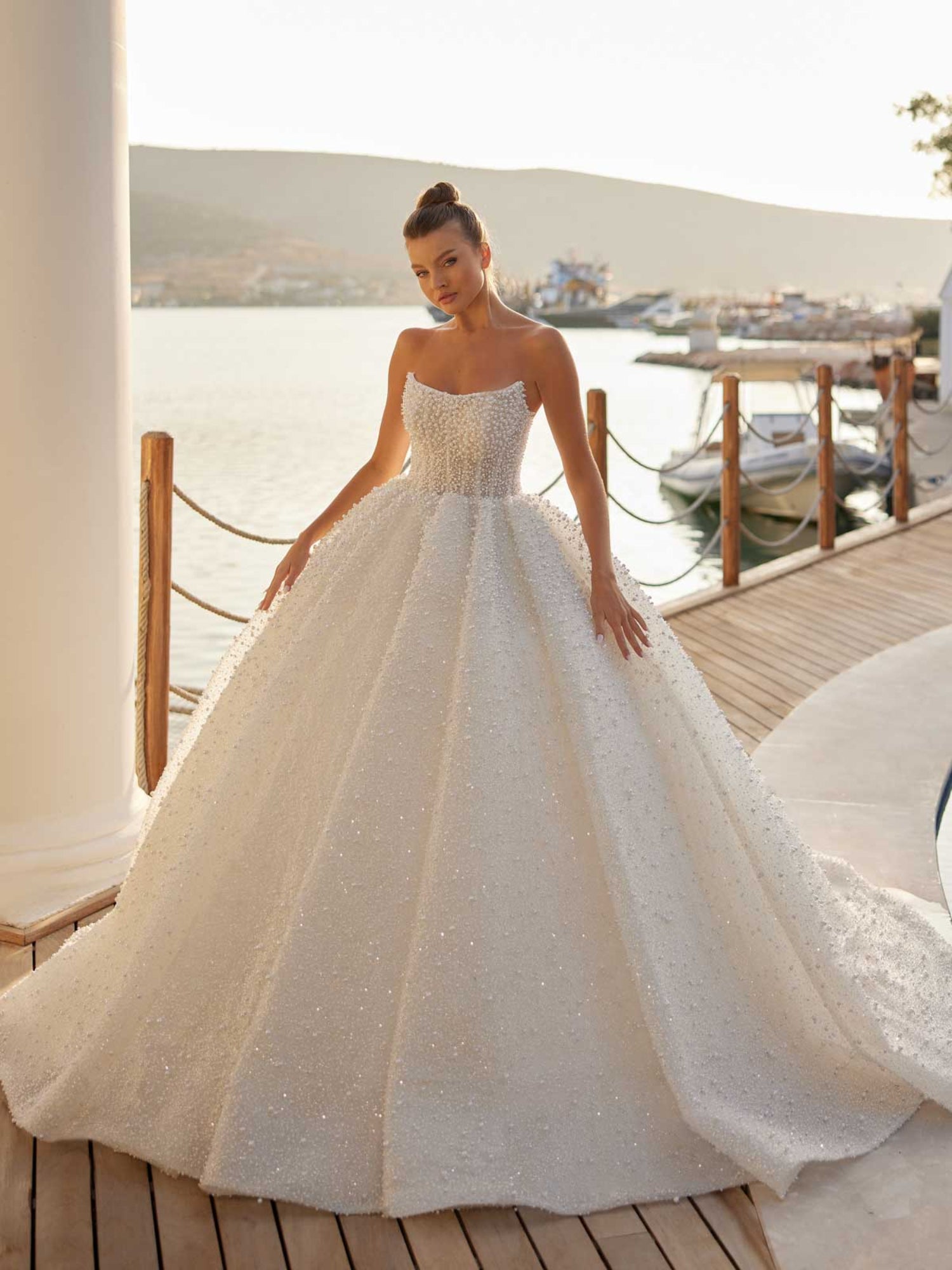 Front view of the pearl embellished strapless ball gown wedding dress with structured corset bodice by Sultan Dress.