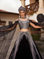 Close-up of the handcrafted silver crystal beadwork, cold-shoulder neckline, and draped lace sleeve on the black velvet top.