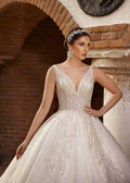 Front view showing the deep V-neckline and hand-beaded leaf embroidery on the sparkle ball gown by Sultan Dress.