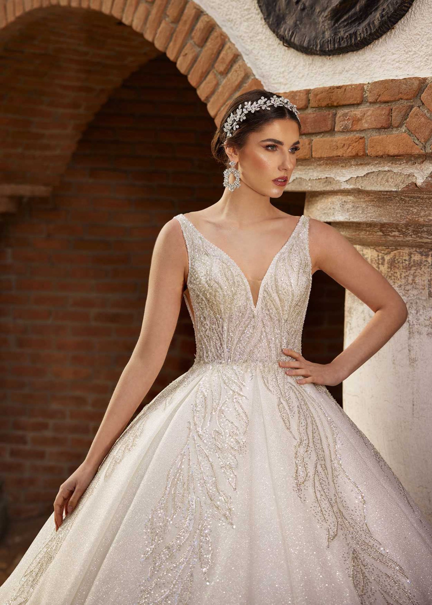 Front view showing the deep V-neckline and hand-beaded leaf embroidery on the sparkle ball gown by Sultan Dress.