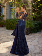 Rear view showing the open illusion back cut-outs and sequin beadwork on the navy blue designer evening gown.