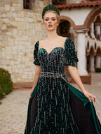 Close-up of the handcrafted pearl and crystal embroidery, sweetheart neckline, and puff sleeves on the emerald velvet dress.
