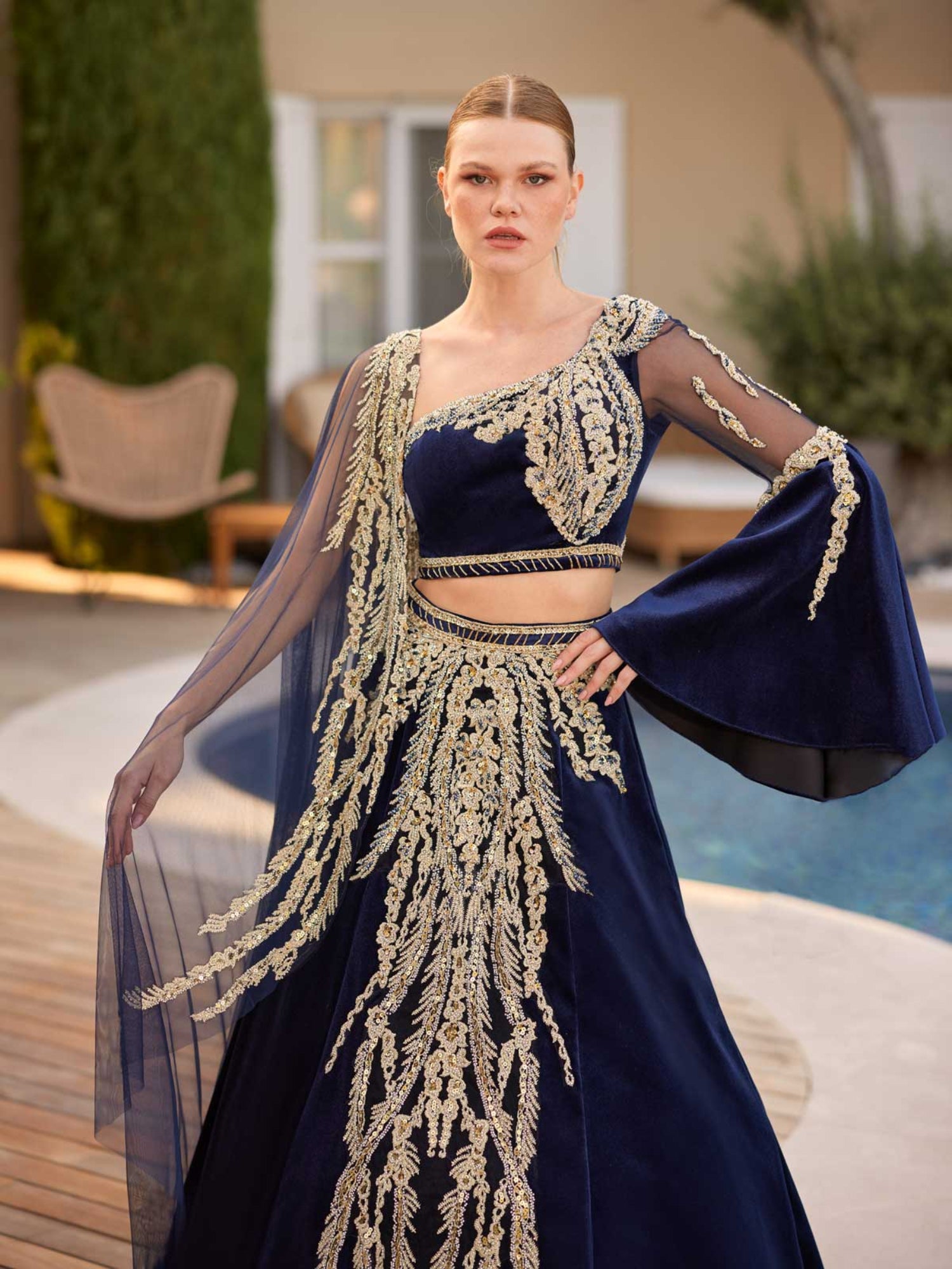 Close-up of the handcrafted gold sequin filigree embroidery, high-waist velvet waistband, and crop top bodice details.