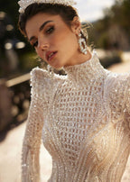 Close-up detail of the hand-stitched beaded fringe tassels, geometric sequin netting, and structured shoulder pads.