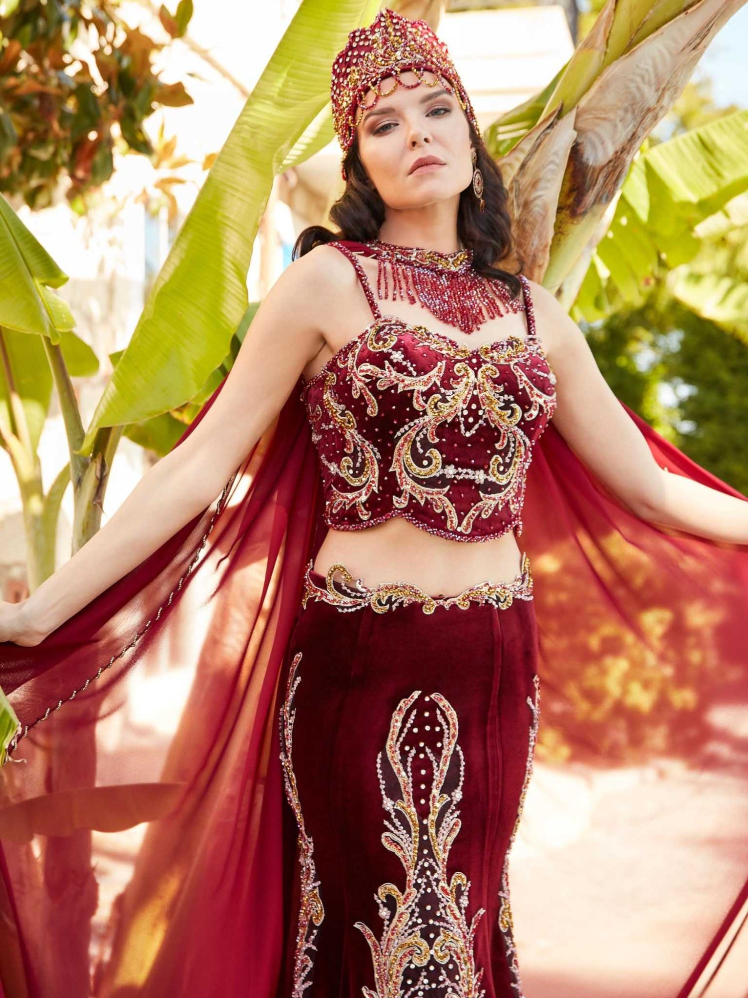 Full-length front view of the red mermaid gown lehenga designer dress with gold embroidery by Sultan Dress.