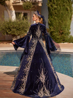 Close-up of the handcrafted silver filigree embroidery, crystal sparkles, and feather trim details on the royal blue velvet dress.