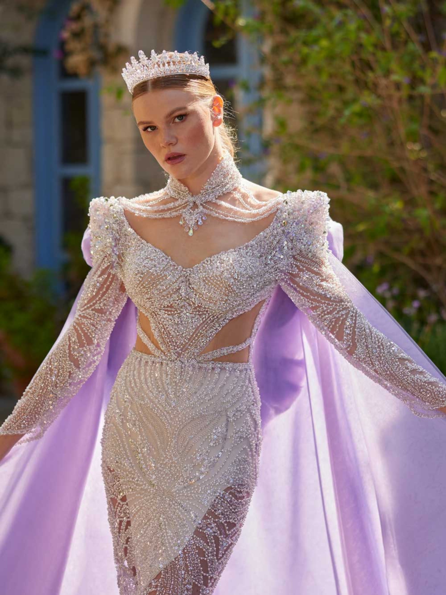 Close-up of the handcrafted silver sequin lines, crystal beaded choker neckline, and illusion cut-outs on the white fitted party dress.